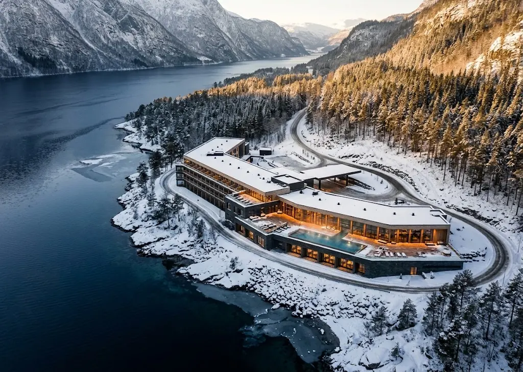 Artist's impression of the resort seen from the air, its low terraces following a snowy peninsula into the fjord